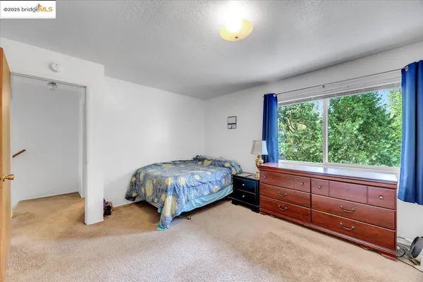 a bed room with a bed and a window