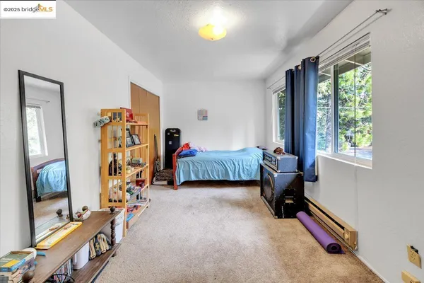 a bedroom with bed and a window