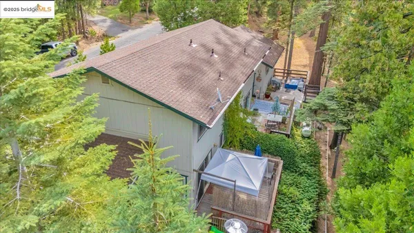 a aerial view of a house with yard and outdoor space