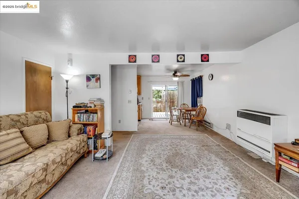 a living room with furniture and kitchen view