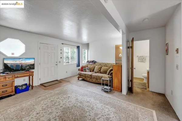 a view of a livingroom with furniture and white walls