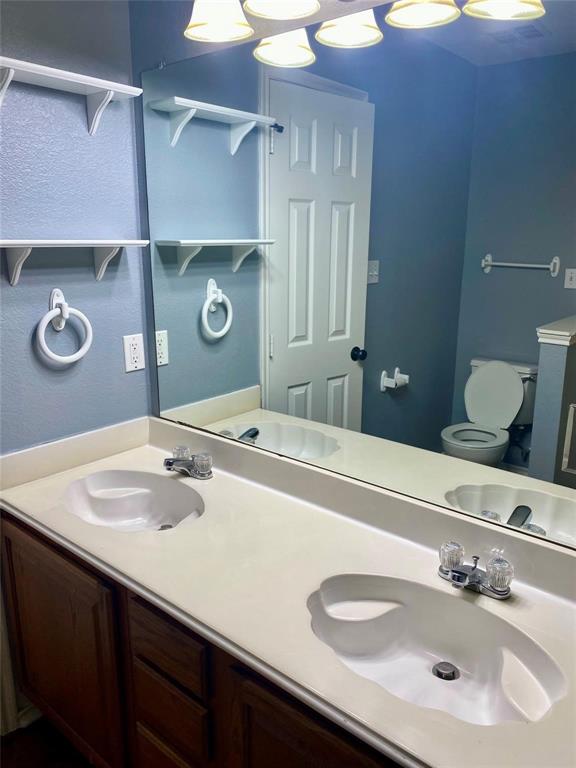 203 Jacinth Lane Granbury, TX 76049 - Photo 14 of 20 a bathroom with a sink and a mirror