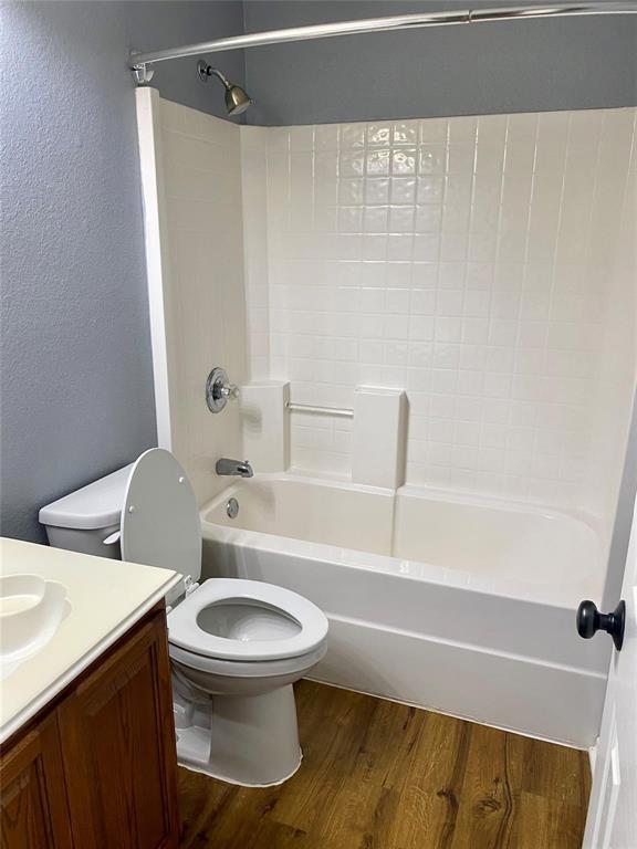 203 Jacinth Lane Granbury, TX 76049 - Photo 19 of 20 a white toilet sitting next to a bath tub