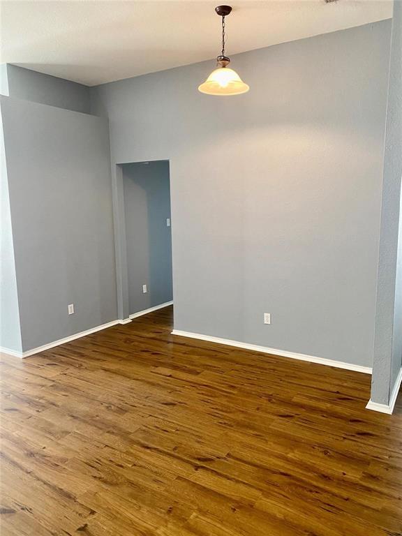 203 Jacinth Lane Granbury, TX 76049 - Photo 7 of 20 a view of an empty room with wooden floor