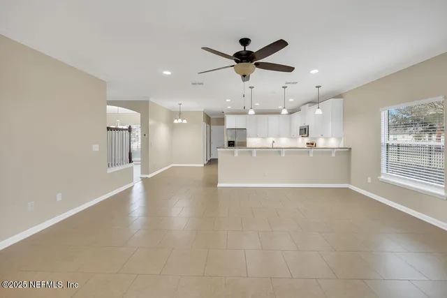 a view of a kitchen with a sink and a refrigerator