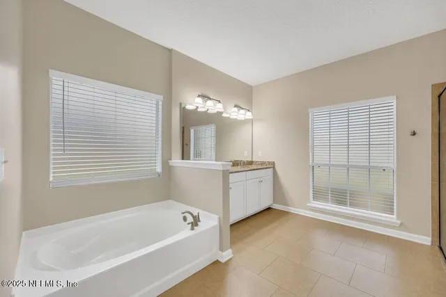 a bathroom with a glass shower door