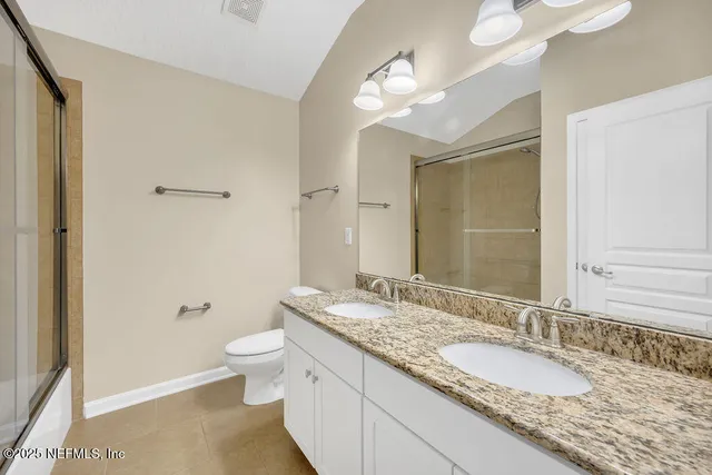 an empty room with closet and windows