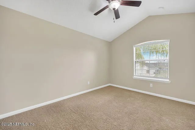 an empty room with closet and windows
