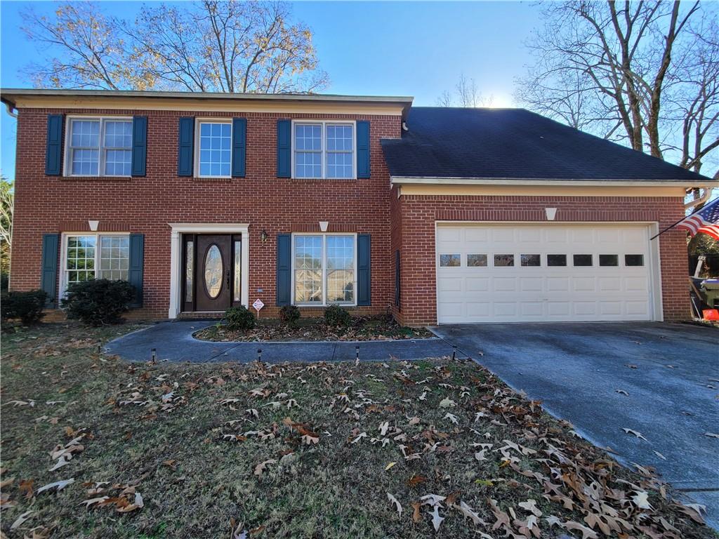 11580 Findley Road Duluth, GA 30097 - Photo 1 of 1 Colonial house featuring a garage