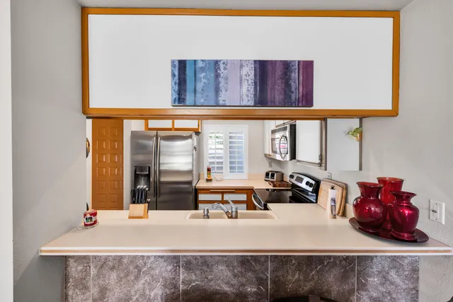 a kitchen with a sink and a mirror