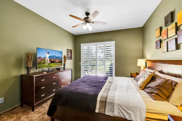 a en suite bathroom with a granite countertop sink a mirror and a shower