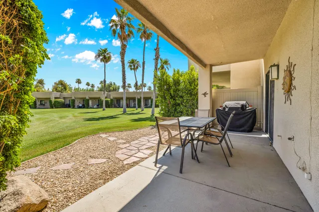 a view of a swimming pool and outdoor seating
