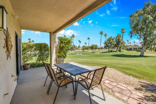a view of a house with backyard porch and sitting area