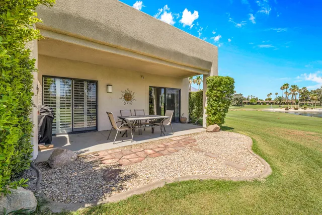 a view of a house with backyard porch and sitting area