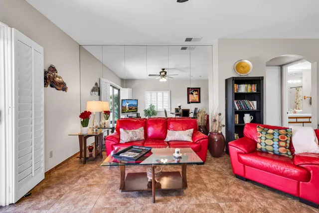 a living room with furniture and kitchen view