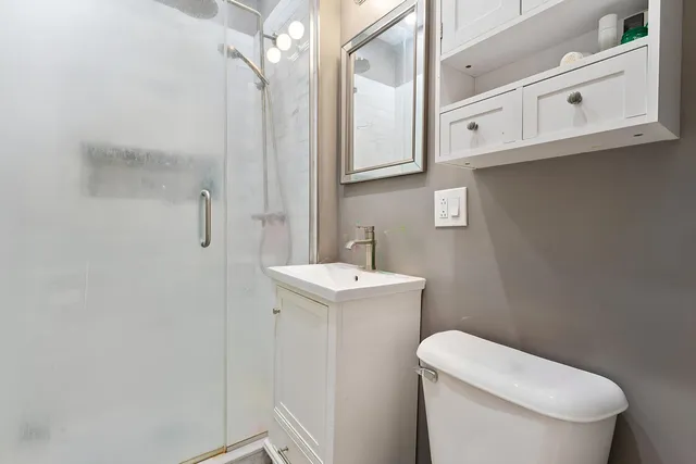 a white toilet sitting next to a bathroom sink
