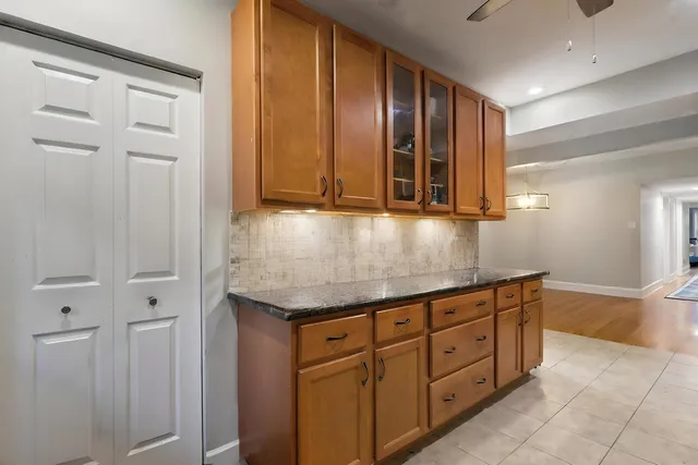a kitchen with granite countertop wooden cabinets and granite counter tops