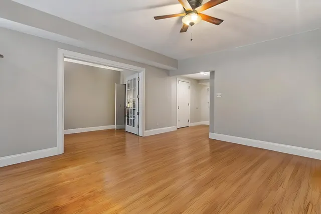wooden floor in an empty room with a window
