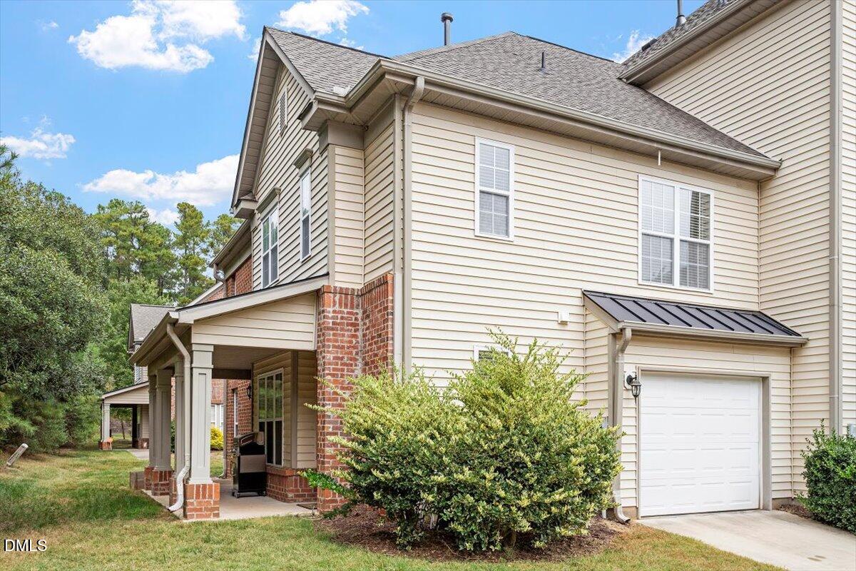 9912 Wasser Court Raleigh, NC 27617 - Photo 5 of 7 a front view of a house with a yard and garage