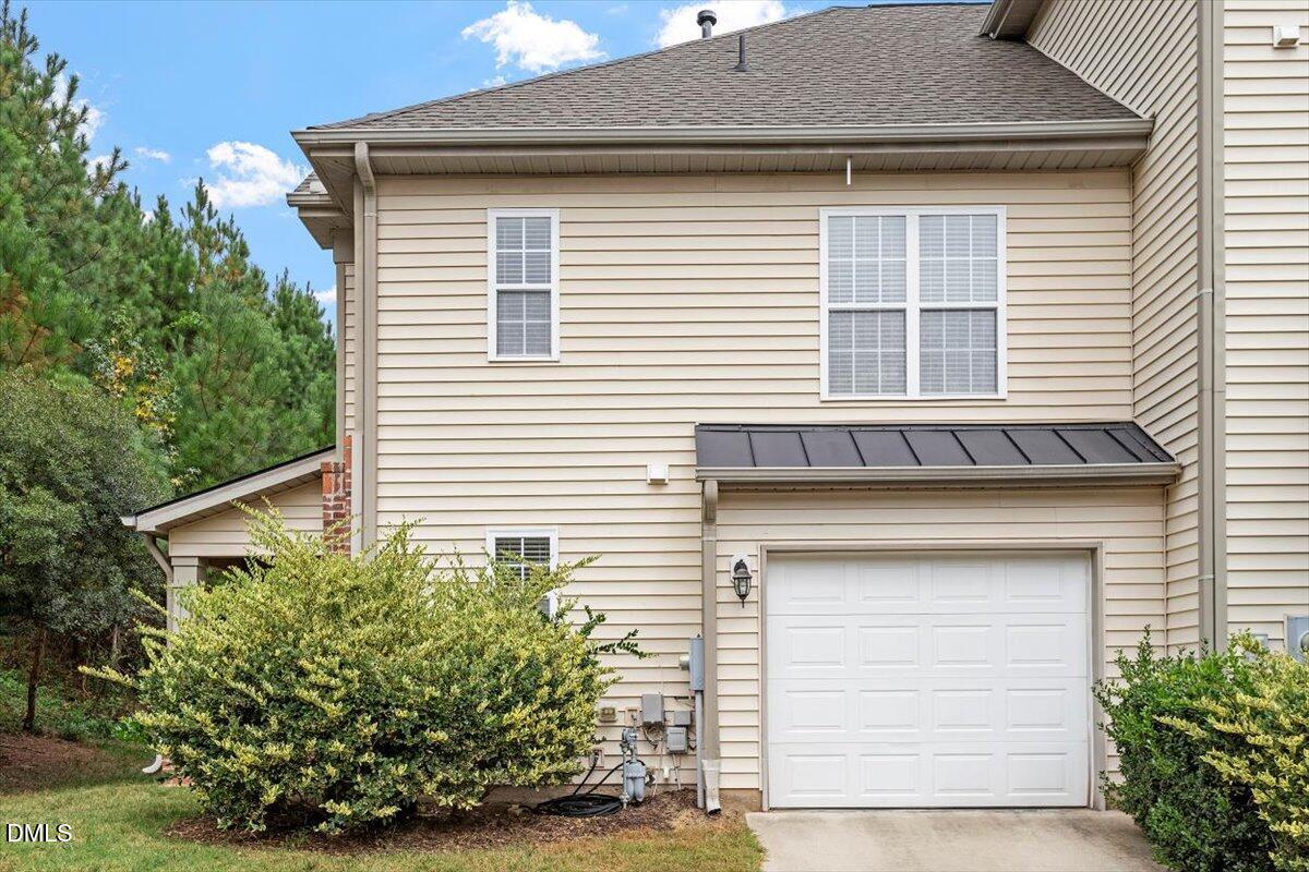 9912 Wasser Court Raleigh, NC 27617 - Photo 6 of 7 a front view of a house with a yard and garage