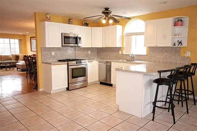 a kitchen with a stove a sink and a microwave