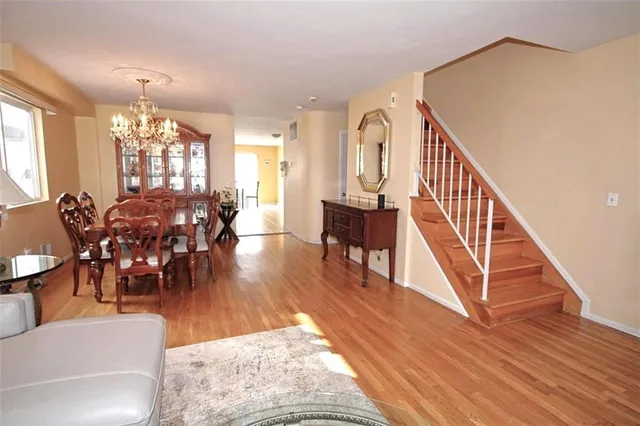 a view of dining room and livingroom with lots of furniture and wooden floor