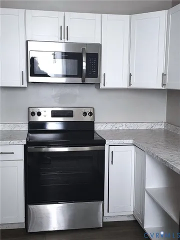 a stove top oven sitting inside of a kitchen