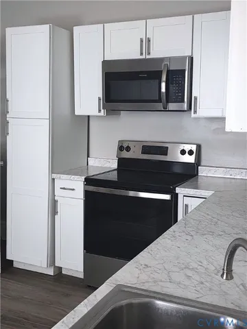 a kitchen with a appliances and cabinets