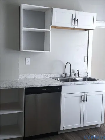 a sink with cabinets and wooden floor