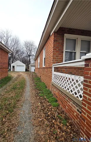 a view of a yard with wooden fence