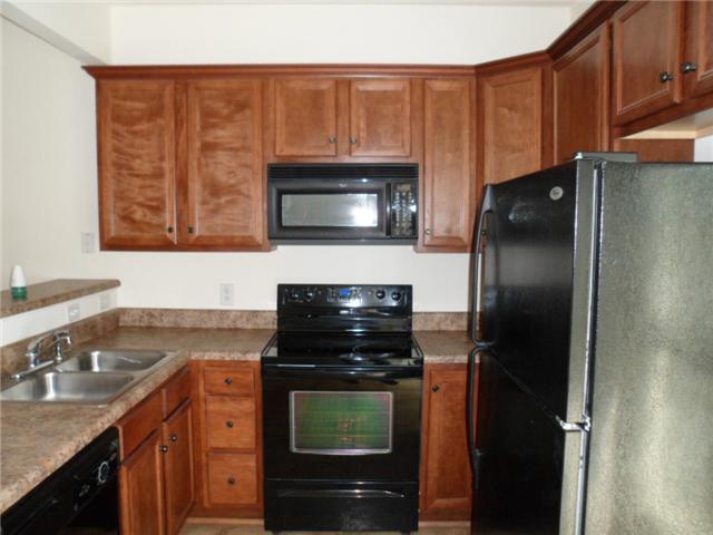 4022 Clinton Lane Spring Hill, TN 37174 - Photo 7 of 16 a kitchen with a refrigerator stove and microwave