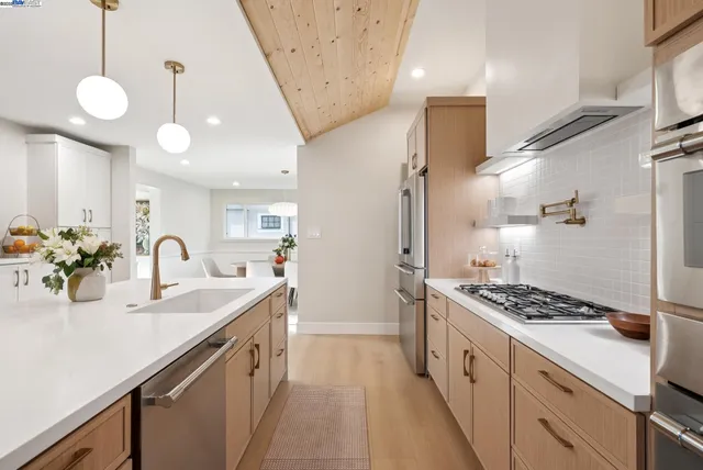 a kitchen with counter top space and stainless steel appliances