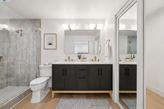 a spacious bathroom with a double vanity sink and a mirror