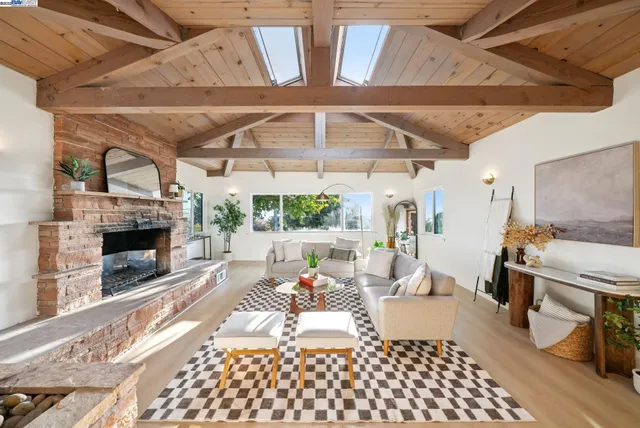 a living room with furniture a fireplace and a table