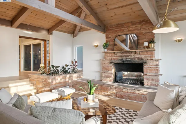 a living room with furniture a fireplace and a table