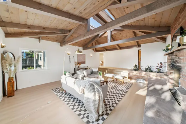 a kitchen with stainless steel appliances kitchen island hardwood floor sink and stove