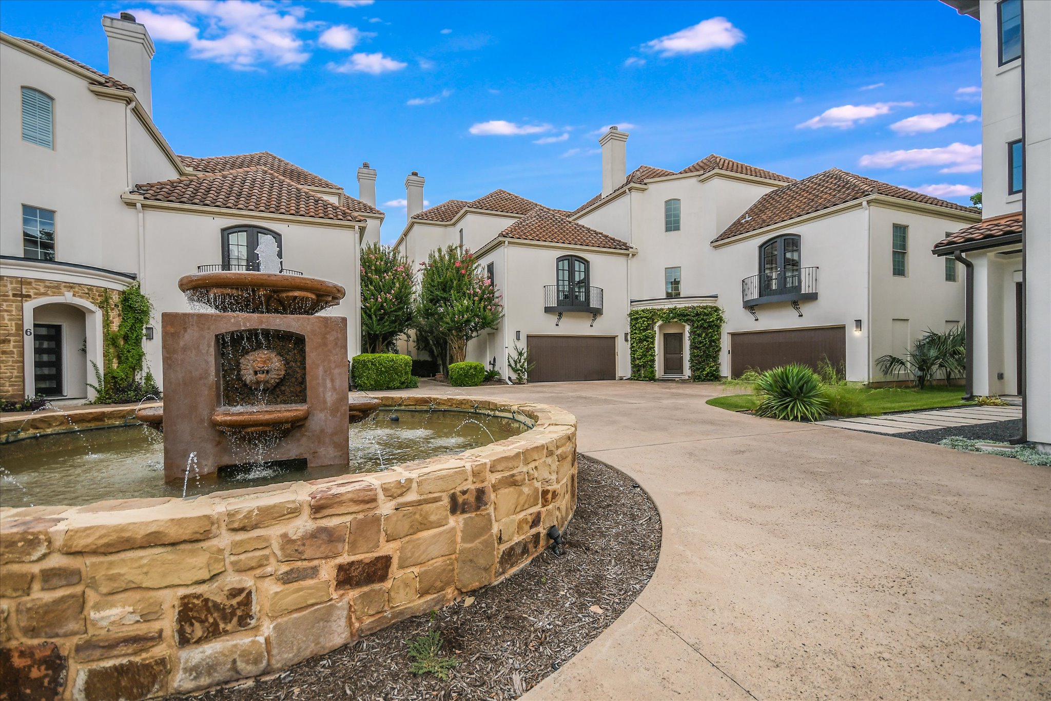 View of property's community with a garage and concrete driveway