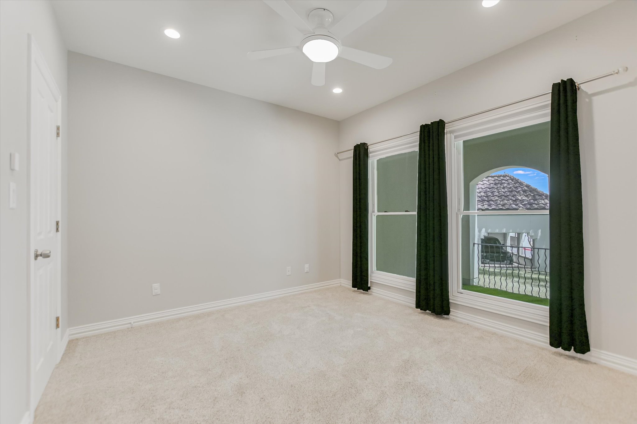 1910 Rue De St Tropez, Unit 4 Austin, TX 78746 - Photo 13 of 36 Unfurnished bedroom featuring light carpet, recessed lighting, and ceiling fan