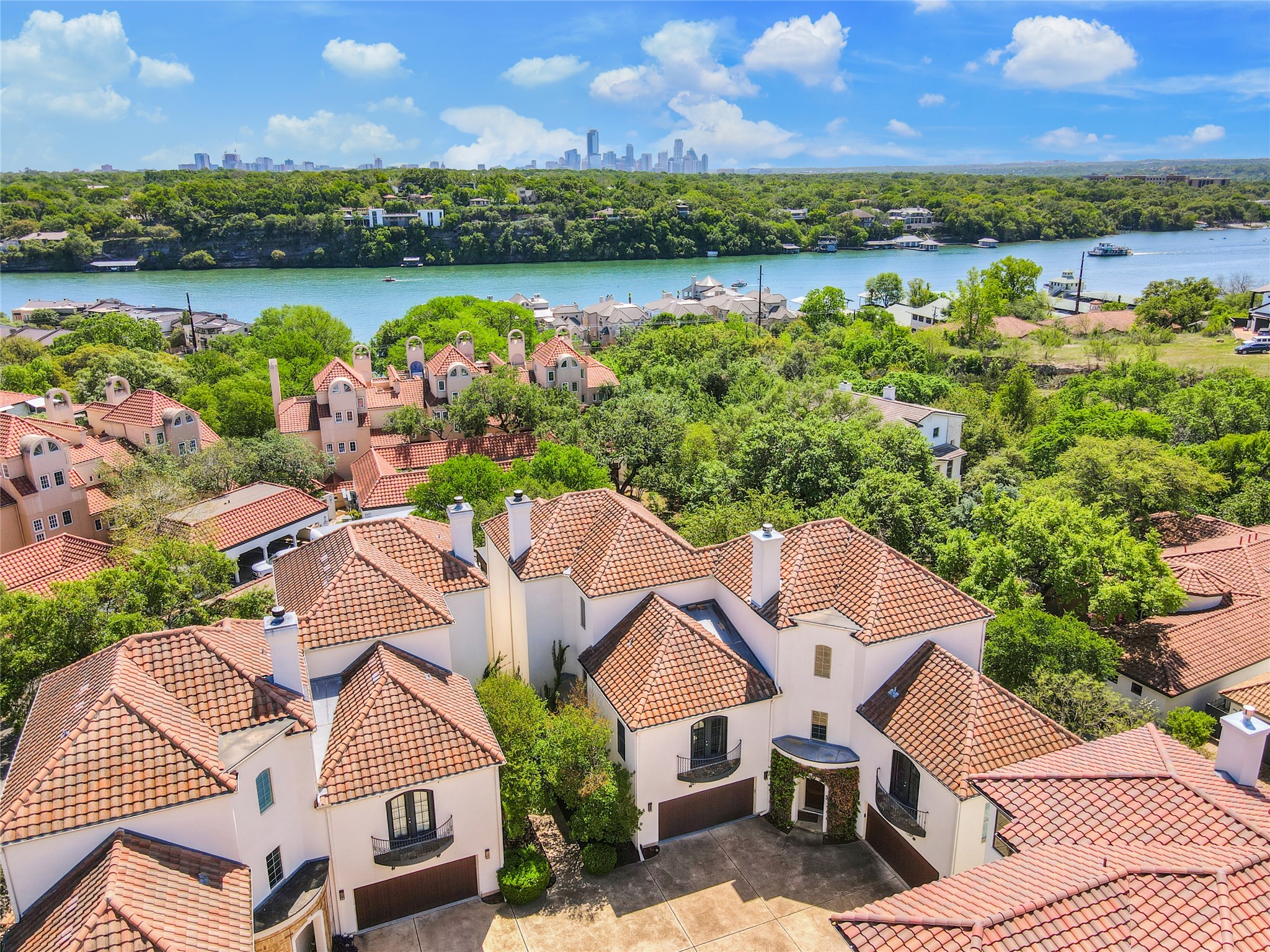 1910 Rue De St Tropez, Unit 4 Austin, TX 78746 - Photo 31 of 36 Aerial perspective of suburban area featuring city skyline and a large body of water