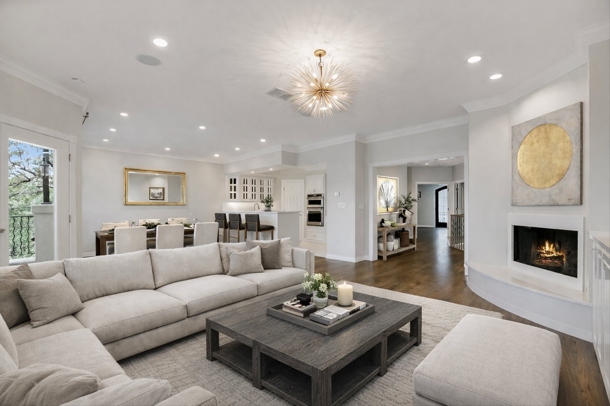 1910 Rue De St Tropez, Unit 4 Austin, TX 78746 - Photo 5 of 36 Living area featuring ornamental molding, wood finished floors, recessed lighting, and a lit fireplace