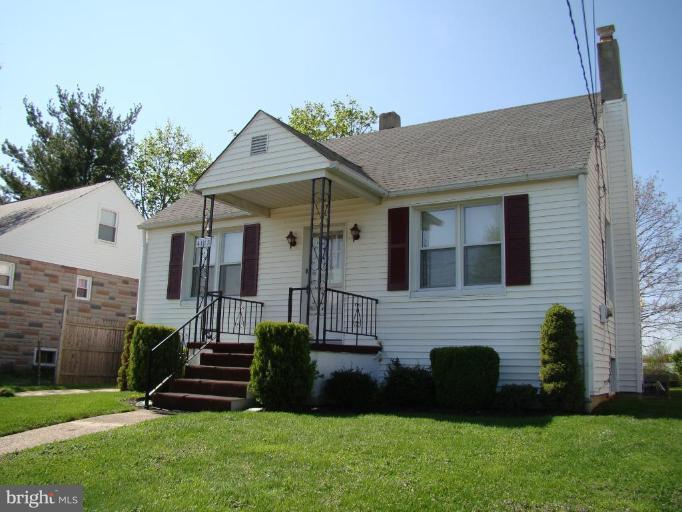 4113 Cliffvale Road Nottingham, MD 21236 - Photo 1 of 8 a front view of a house with a garden
