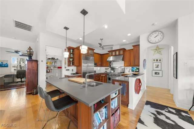 a open kitchen with stainless steel appliances granite countertop a stove and refrigerator