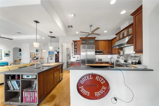 a kitchen with stainless steel appliances granite countertop a sink stove and cabinets