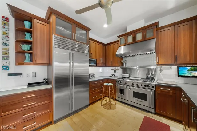 a kitchen with stainless steel appliances granite countertop a stove and a refrigerator