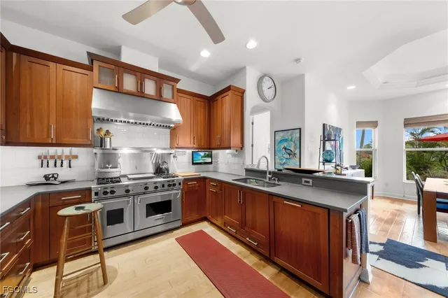 a kitchen with stainless steel appliances granite countertop a stove and a sink