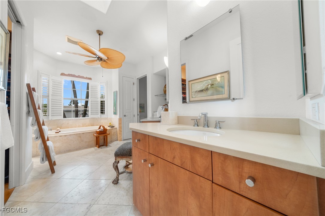 4424 North Bay Circle North Fort Myers, FL 33903 - Photo 19 of 43 a spacious bathroom with a sink a large mirror and a bathtub