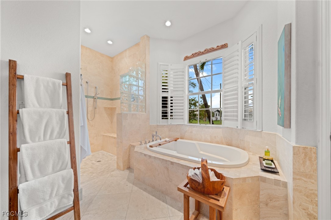 4424 North Bay Circle North Fort Myers, FL 33903 - Photo 20 of 43 a bathroom with a tub sink and a mirror