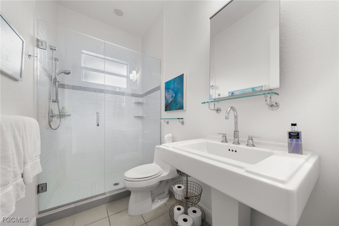 4424 North Bay Circle North Fort Myers, FL 33903 - Photo 23 of 43 a bathroom with a sink a toilet and shower