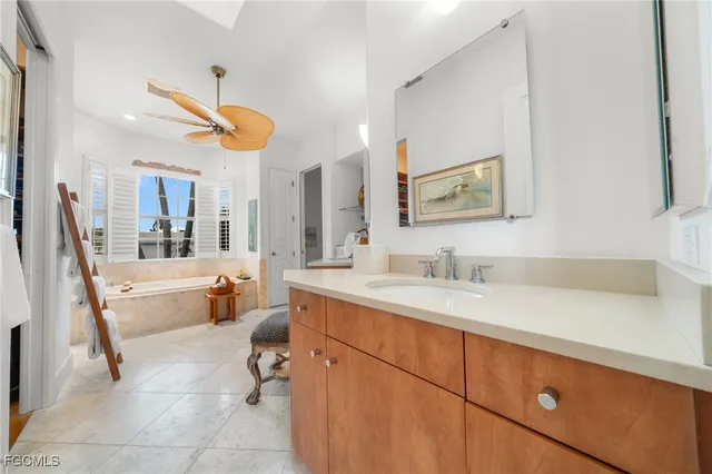 a spacious bathroom with a sink a large mirror and a bathtub