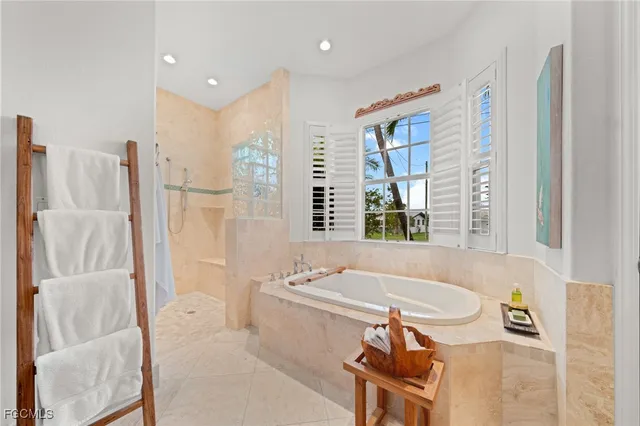 a bathroom with a tub sink and a mirror